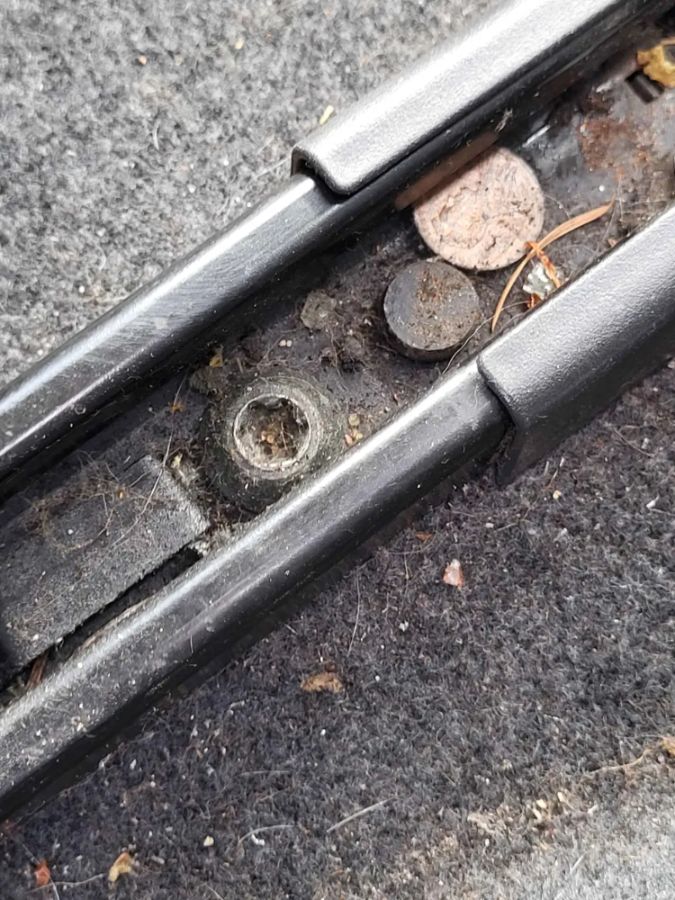 Dirt and debris packed into seat rails and seams